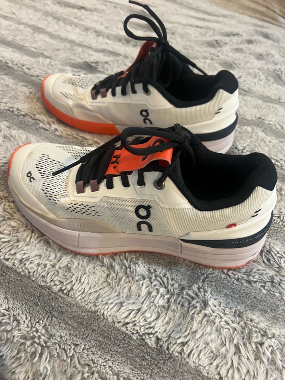 On Running Women's Sneakers in White and Black with Orange Trim